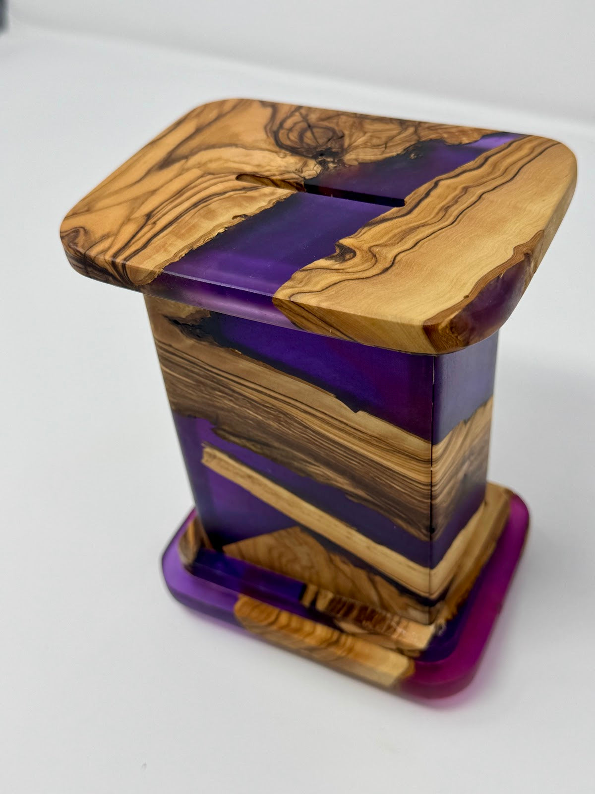 Israeli olive wood charity box – angled view showing violet resin river through the grain