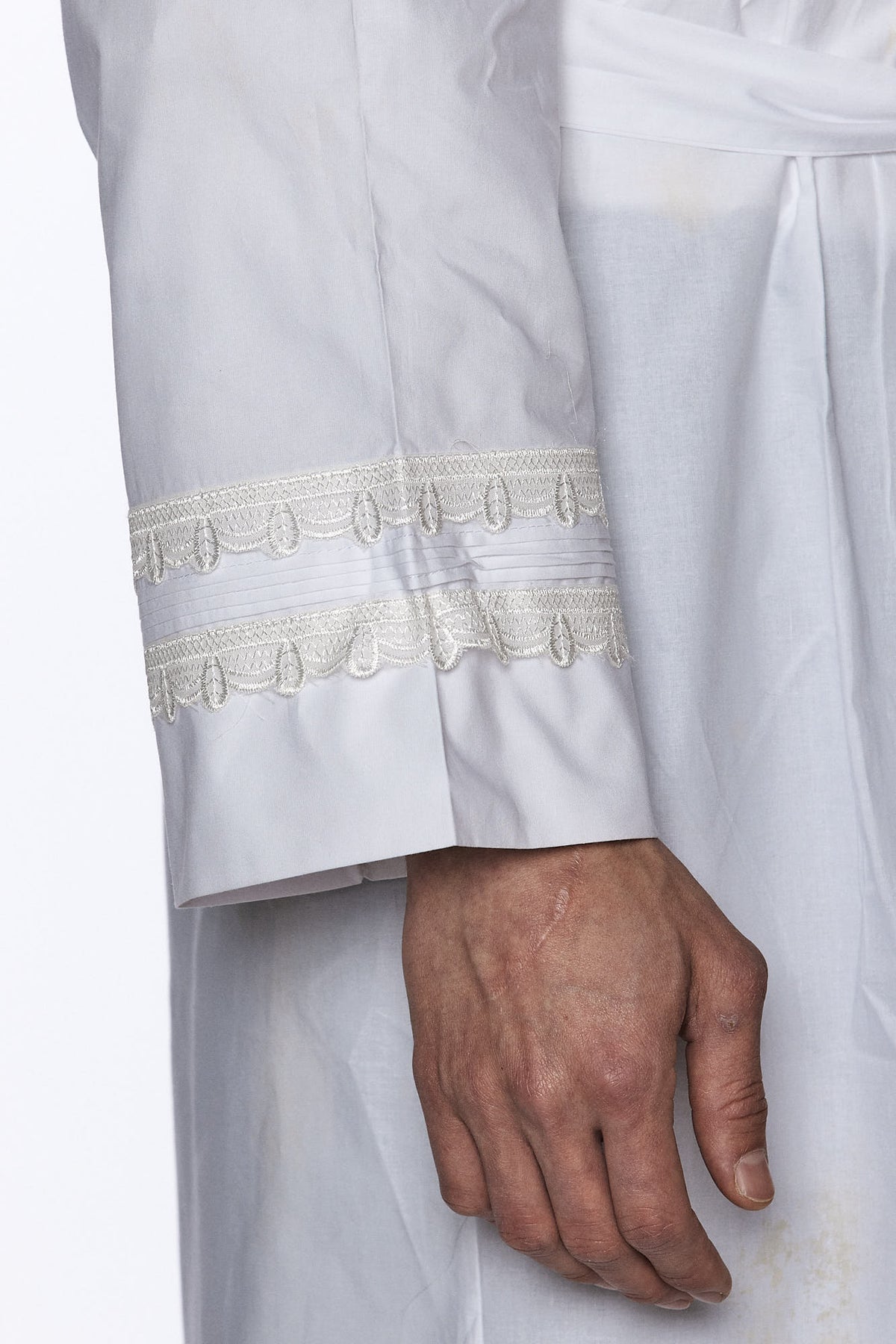 Kittel with lace detail, shown with its matching belt | MitzvahArt