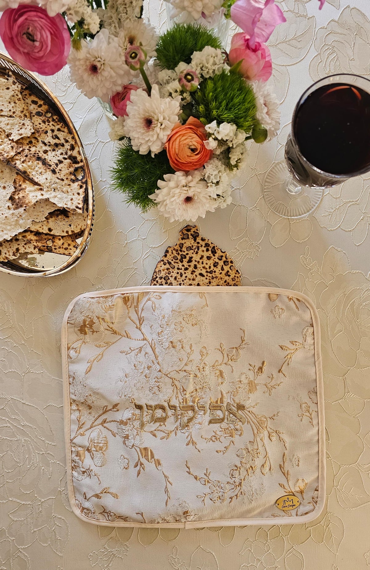 Rosed Bloom matzah set shown on the seder table | MitzvahArt