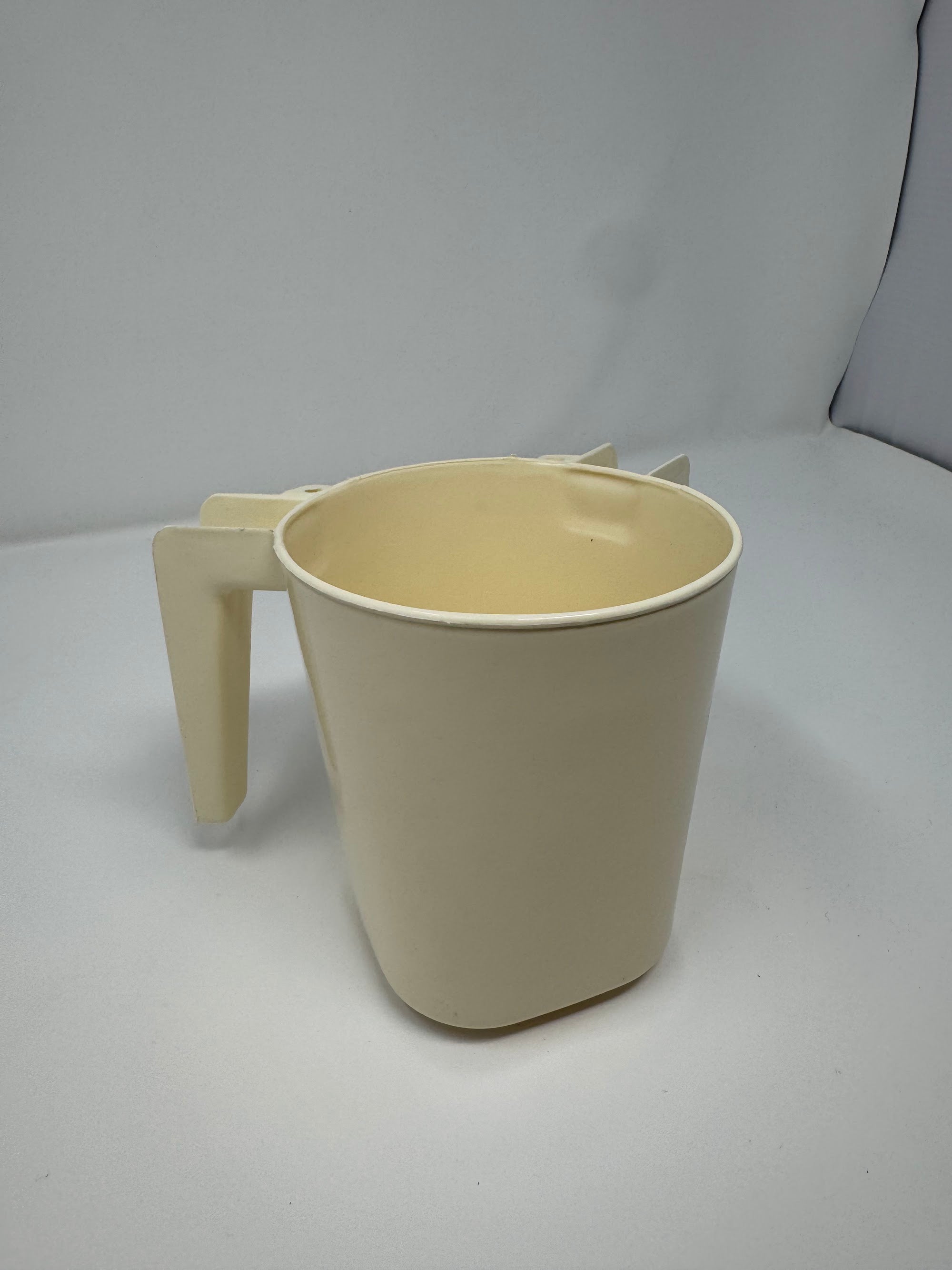 Cream plastic washing cup, angled view showing the interior | MitzvahArt