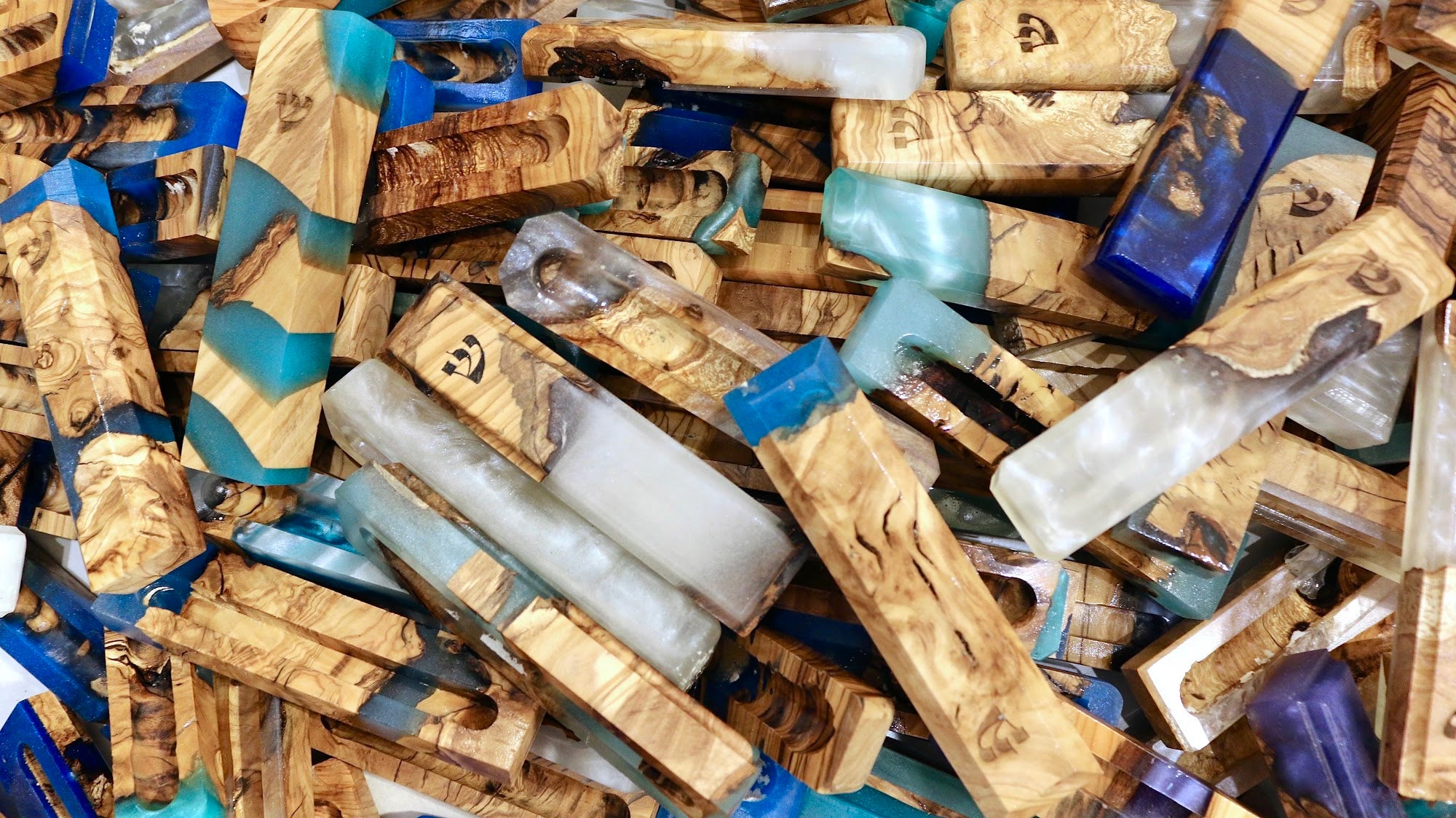 Assorted handmade mezuzah cases in olive wood and coloured resin | MitzvahArt