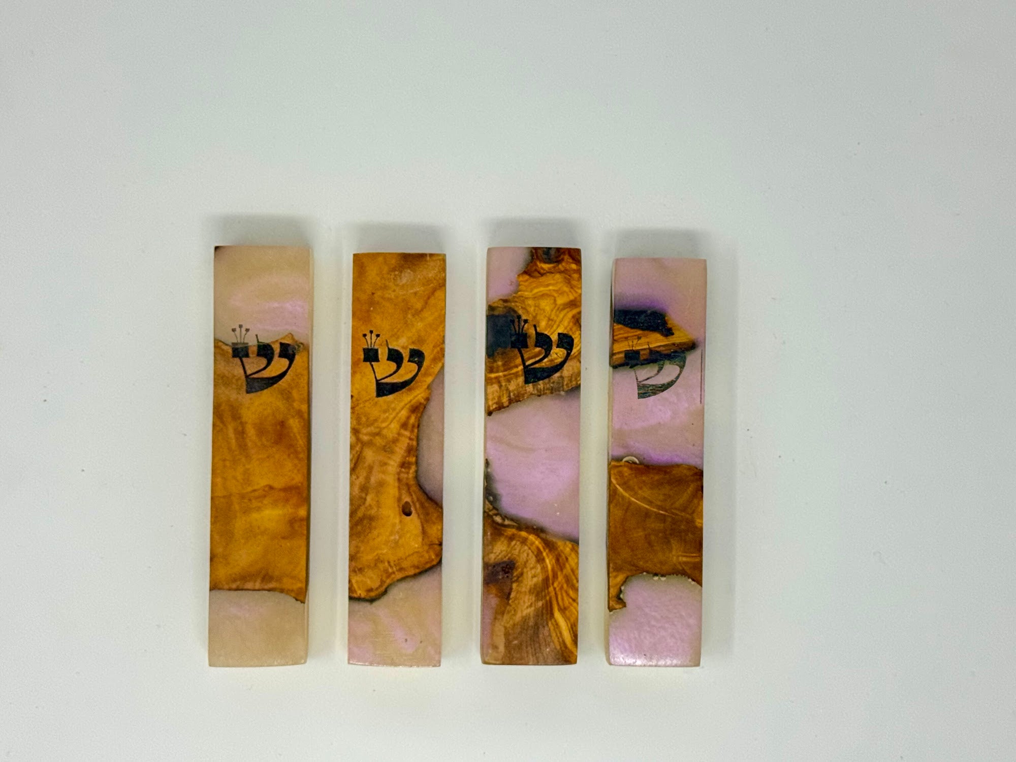 Pink olive wood and resin mezuzah cases shown as a set, 10 cm | MitzvahArt
