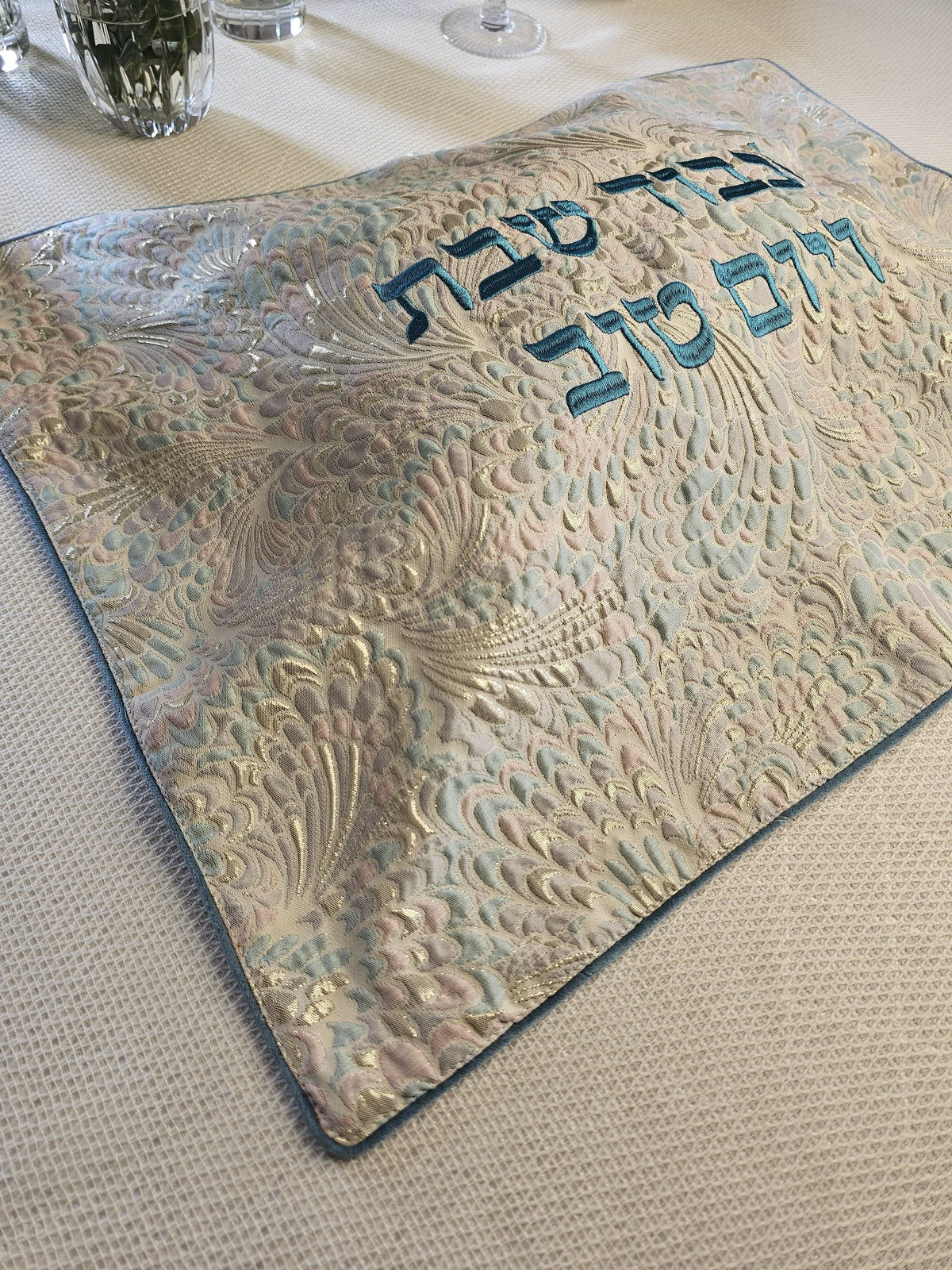 Wintered Mermaid challah cover shown on the Shabbos table | MitzvahArt